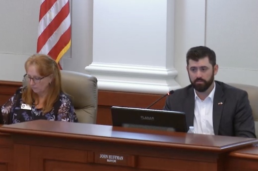 man speaks behind dais