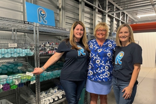 From left, President and Founder Elizabeth Watkins , Advisory Council Member Susie Fogerson, and Operations and Inventory Manager Anja Newbury gather in the Refresh Frisco warehouse where donations are organized. (Sara Rodia/Community Impact)