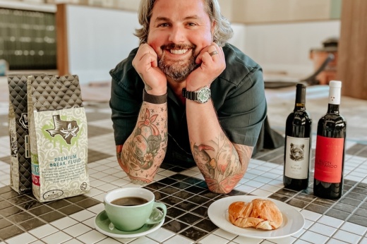 Justin Turner, director of hospitality for McCord Development, which owns Generation Park, stands before an assortment of items that will be offered at Lupo Caffe. (Courtesy McCord Development)