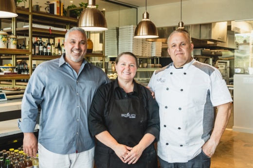 Three people standing together.
