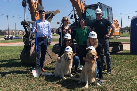 Martin Evans and Gianna Venturi broke ground on the site with their dogs, Cooper (left) and Indie (right), as well as with representatives from N3, their commercial development and real estate partner. (Courtesy Strickland Brothers 10 Minute Oil Change)
