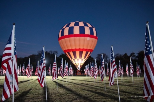 hot air balloon surrounded by American flags