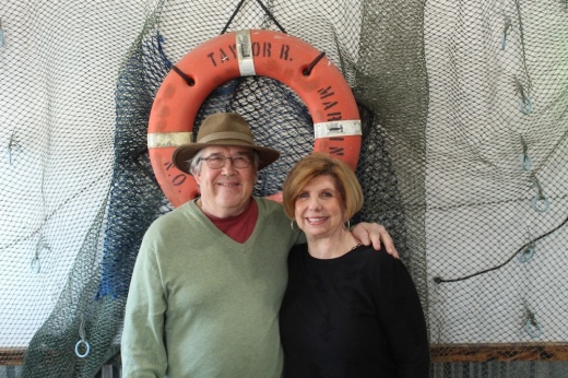 man and woman standing in front of a ring buoy 