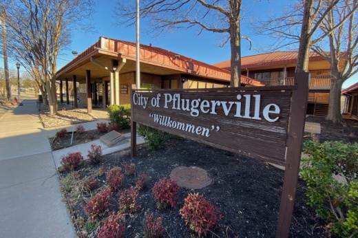 Photo of a sign reading "City of Pflugerville, Willkommen"