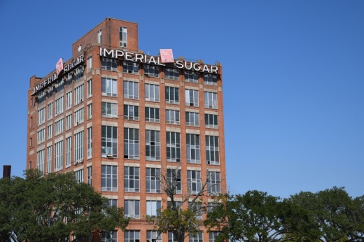 Photo of a tall brick building with an "Imperial Sugar" sign