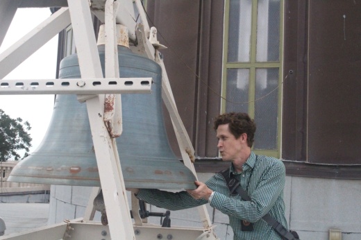 County Architect Trenton Jacobs examines the bell on top of the Williamson County Courthouse.