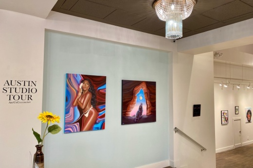 Paintings hanging on display wall in an art gallery