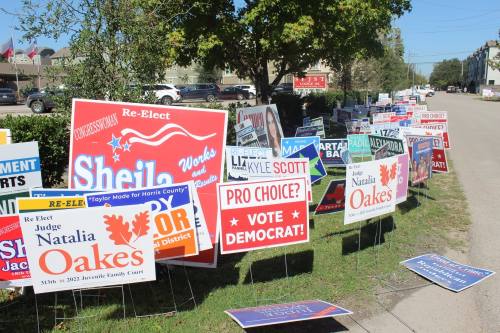 Candidate signs line the front of the SPJST Lodge, one of many polling places open on Election Day in the Heights. (Shawn Arrajj/Community Impact)