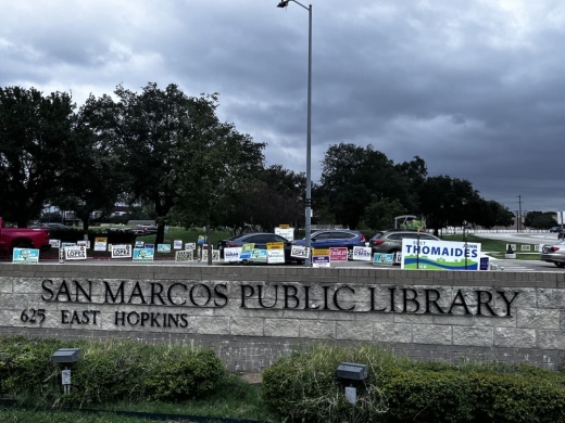 Political signs adorn the San Marcos Library ahead of voting Nov. 8. (Heather Demere/Community Impact)