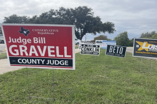 Campaign signs sit outside the Georgetown ISD polling location. (Grant Crawford/Community Impact)
