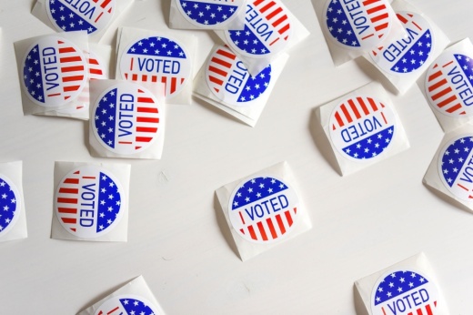Stickers that say 'I voted' on a white table