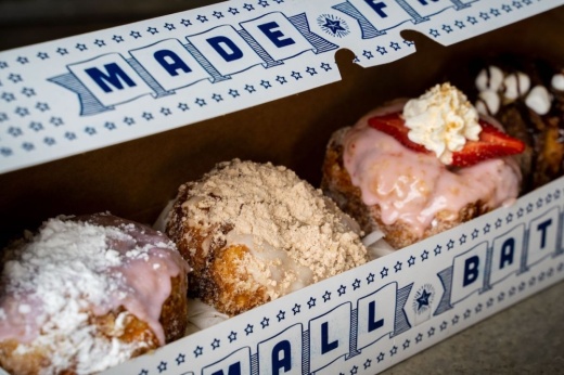 decorated doughnuts in a blue and white box