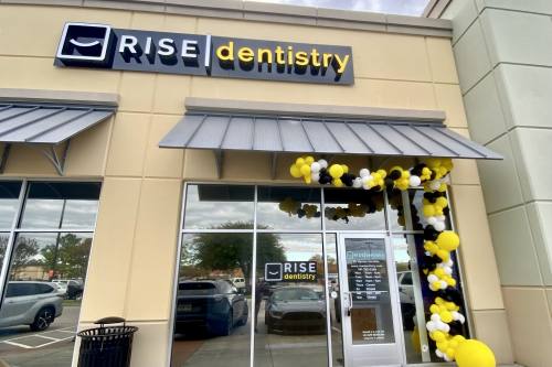 Rise Dentistry building is decorated with black, yellow and white balloons for its grand opening.