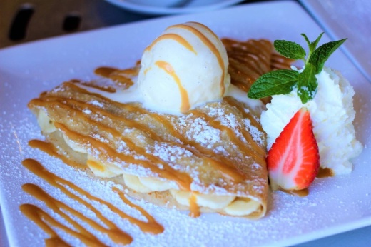 A picture of a crepe with ice cream on top