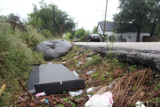 Illegally discarded trash fills a drainage ditch in Independence Heights. (Shawn Arrajj/Community Impact)