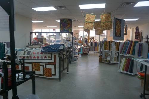 
The shop sells bolts of fabric and other supplies. It also offers long-arm quilting machine rentals.