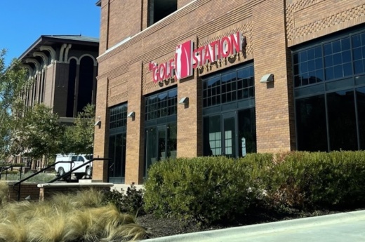exterior of brown building with bushes in front