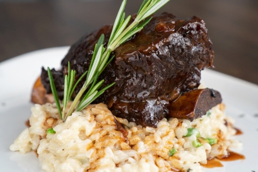 Sicilian braised beef short ribs ($45): These ribs are covered in a balsamic chipotle glaze and laid over a bed of sweet pea risotto. (Courtesy Mia Bella Trattoria)