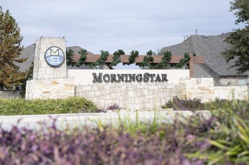 MorningStar neighborhood sign decorated with greenery and plants in front 