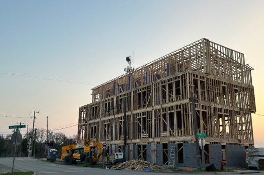 a multifamily housing unit being built in round rock texas with sunset in the background