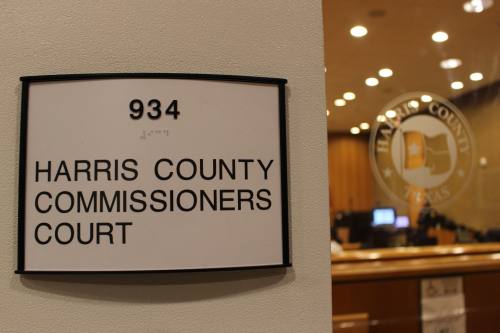 This is a picture of the sign outside the commissioners courtroom that says "Harris County Commissioners Court".