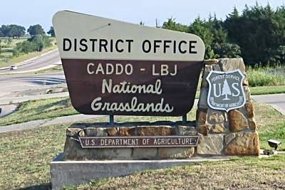 A sign for the district office of the Caddo and Lyndon B. Johnson National Grasslands.