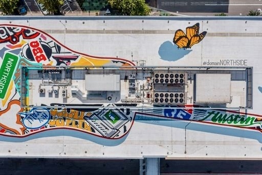 Giant painting of a guitar on a rooftop