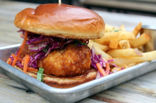 Farm   Feed's Hot Fish Sando is served on a Brioche bun with fries ($15.75). (Karen Chaney/Community Impact)