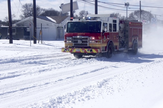 a fire truck drives down an icy neighborhood road