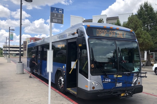 Bus waiting at a bus stop.