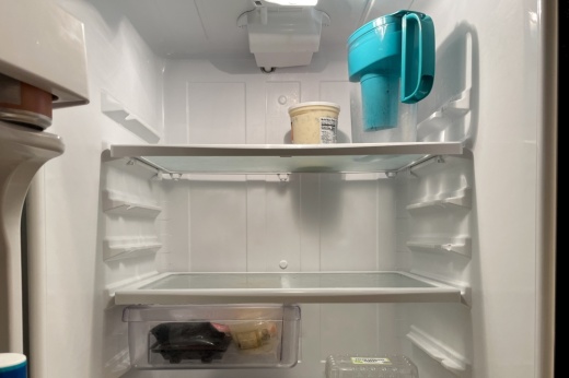 A fridge with a few items inside it.