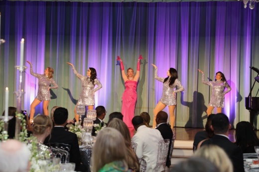 Junior League of Houston members dance and sing on stage to "Diamonds Are a Girl's Best Friend" at the League's Diamond Celebration.
