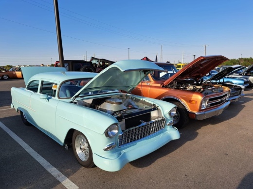 blue and orange vintage cars with the hoods up