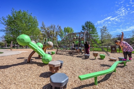 Children play in a new park structure installed at Kinningham Park