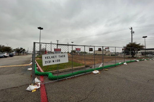 The fence blocking off the section of the shopping center went up March 7, with site work starting the next day, according to a developer of the property. (Brooke Sjoberg/Community Impact)