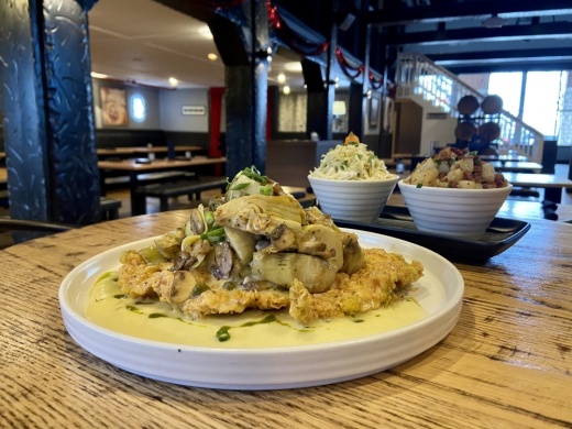 Pork Schnitzel ($19) - topped with mushrooms, artichokes, bacon bits and lemon butter and served with coleslaw and potato salad.