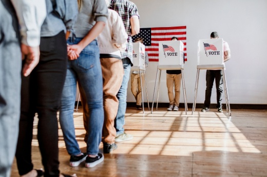 People stand in line to vote.