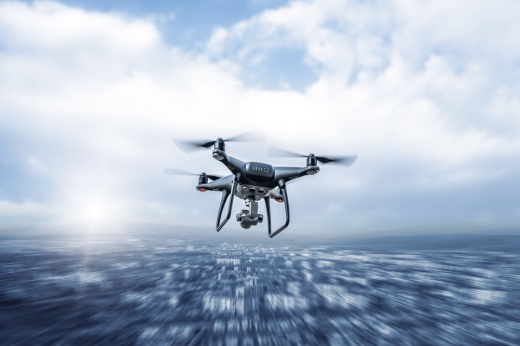 Modern drone in flight over the city.