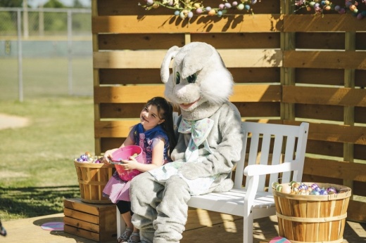 A child poses for a picture with the Easter Bunny