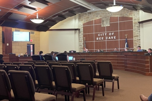 People siting in a city council meeting.
