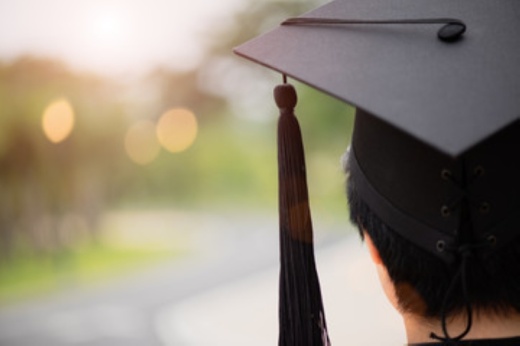 closeup of the back of someone's head with a graduation cap on