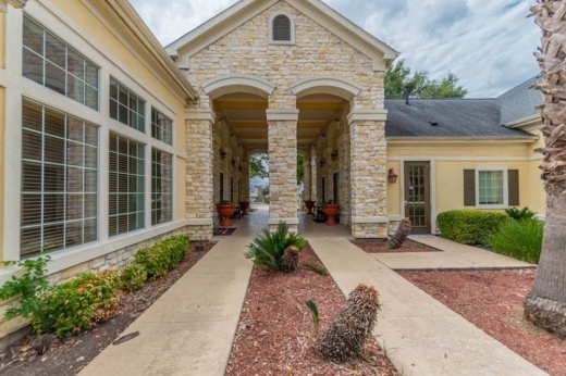 exterior of apartment complex with brick and yellow-painted walls