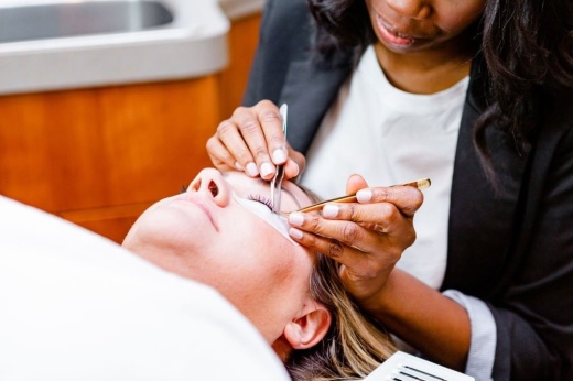 Lumi Beauty Studio owner Ashley Pettus gives a client a lash extension