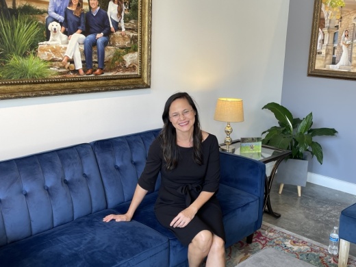 Woman sitting on couch.