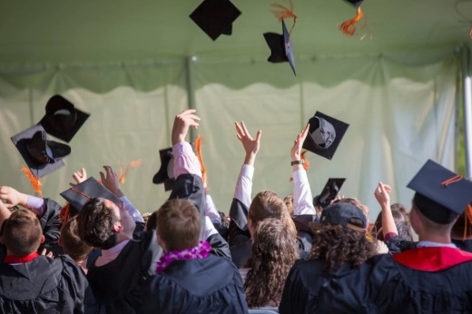 students throw grad caps