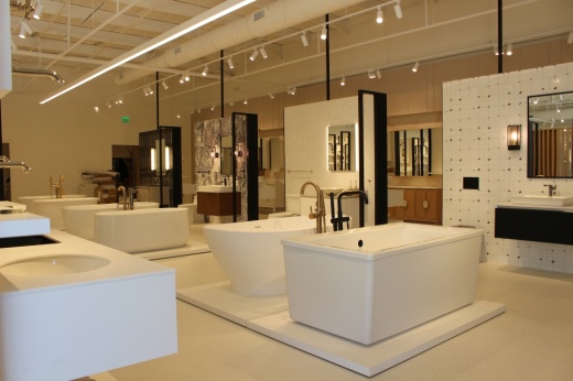 Showroom with multiple bathroom sinks, tubs, and fixtures.