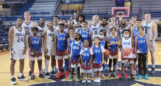 Basketball team lined up on the court
