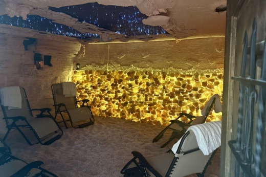 a large salt cave flows yellow surrounded by lounge chairs