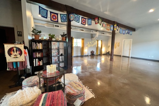 Yoga studio with pillows and a table in front.