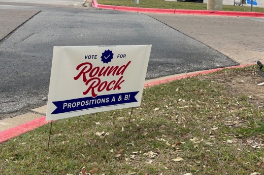 voting sign on a curb